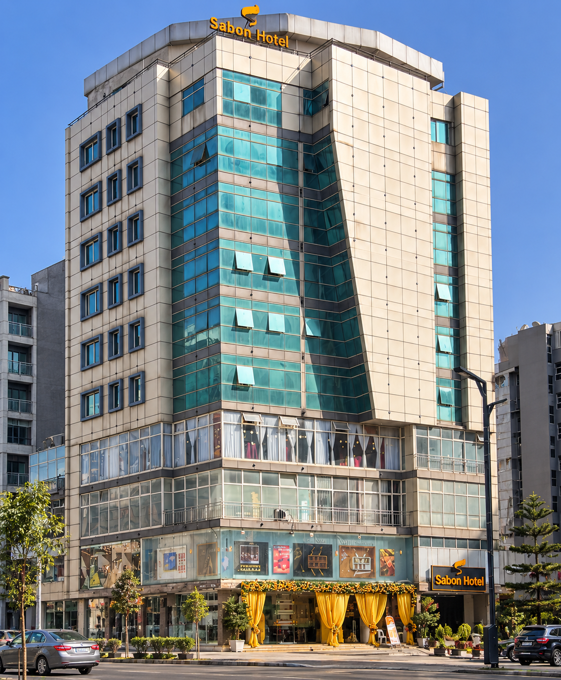 Sabon Hotel exterior with its glass facade, hotel sign, and street entrance