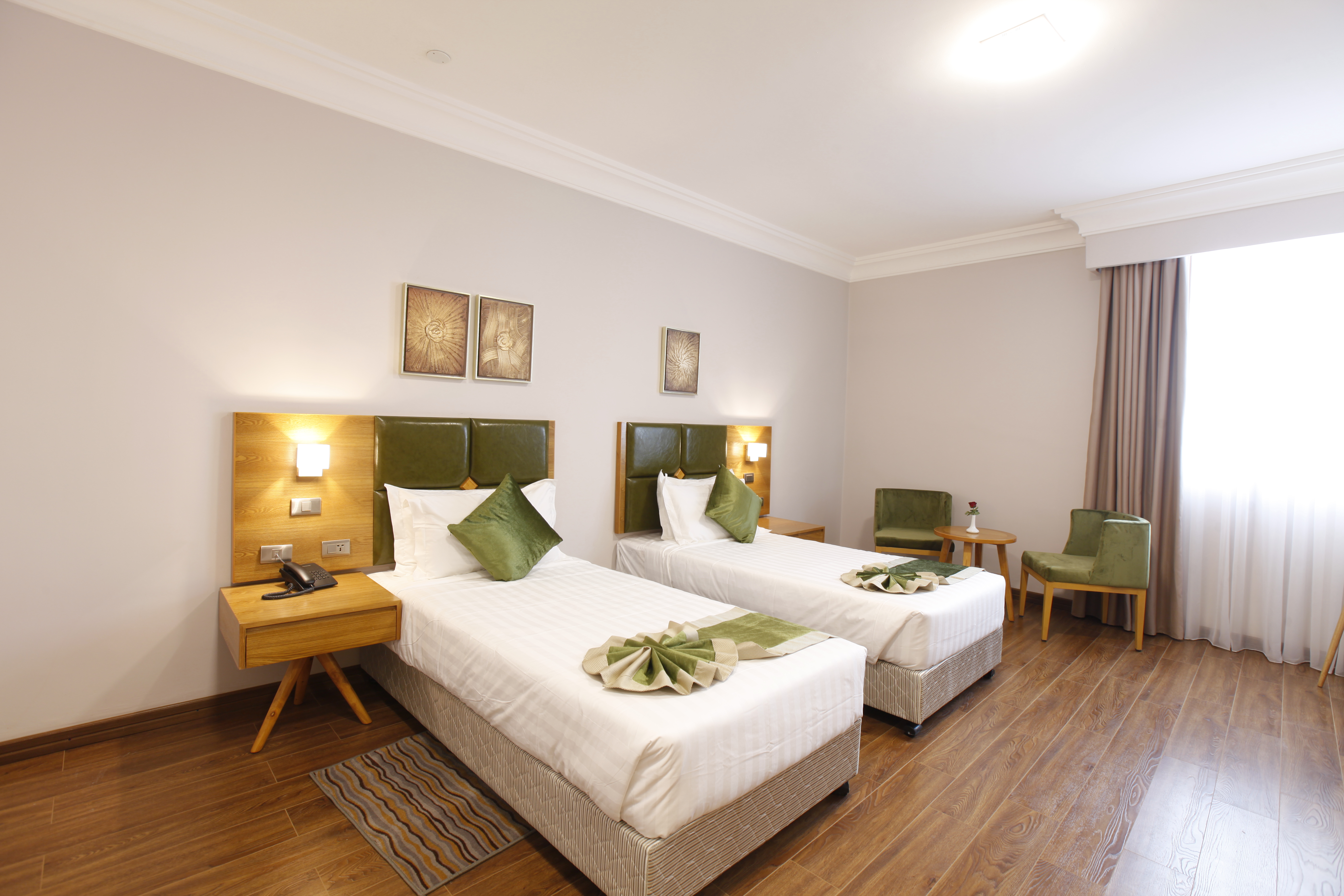 Twin room at Sabon Hotel with two beds and seating by the window